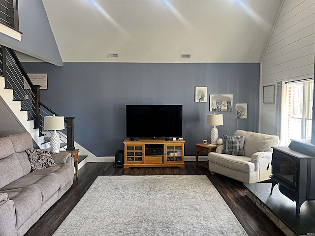 living room featuring visible vents, dark wood finished floors, and stairs