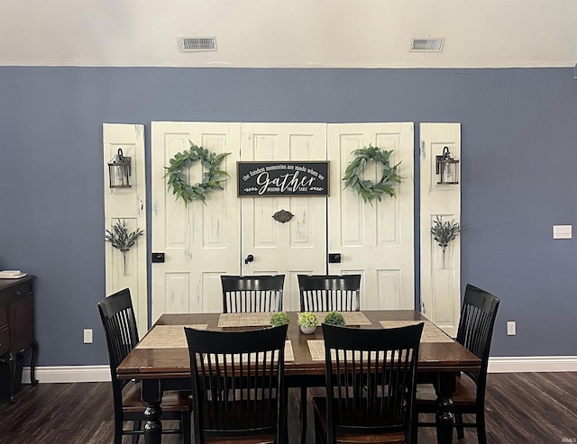 dining space with visible vents, baseboards, and wood finished floors