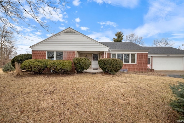 ranch-style home featuring a garage, concrete driveway, brick siding, and a front lawn