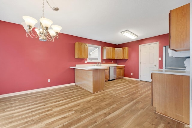 kitchen with light wood finished floors, baseboards, a peninsula, light countertops, and stainless steel dishwasher