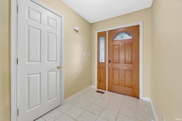 foyer featuring light tile patterned floors, visible vents, and baseboards