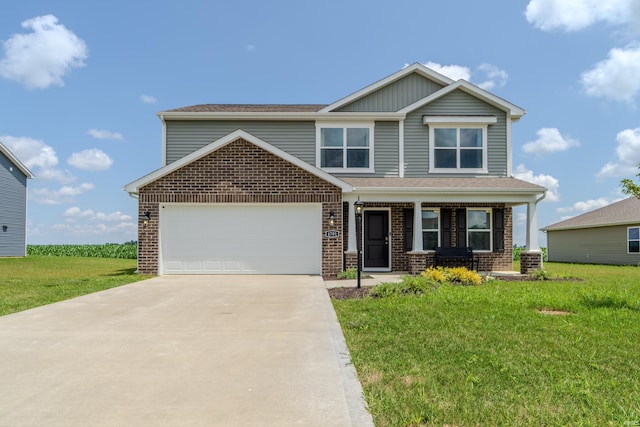 craftsman inspired home featuring a garage, a front yard, concrete driveway, and brick siding