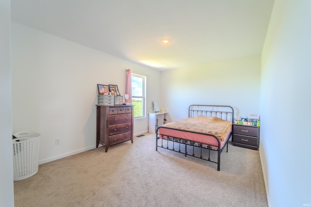 carpeted bedroom with visible vents and baseboards