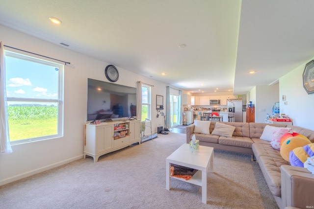 living room featuring light carpet, recessed lighting, visible vents, and baseboards