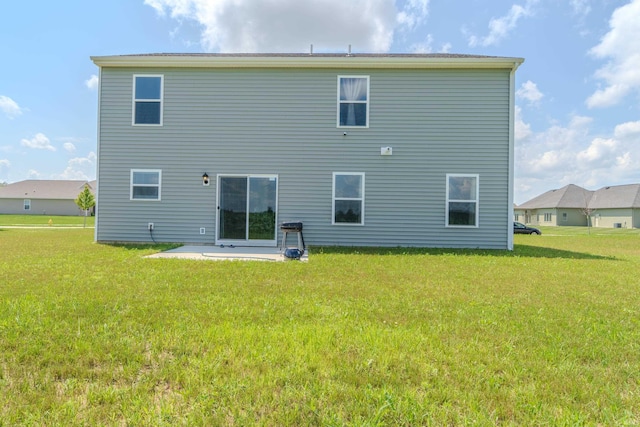 back of house featuring a yard and a patio