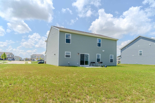 back of house with a yard