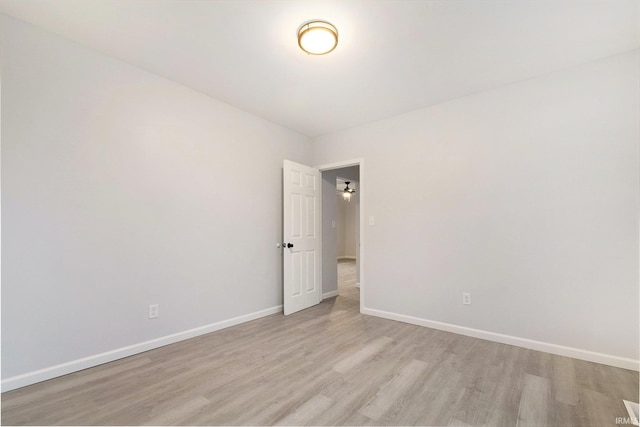 empty room featuring light wood-style floors and baseboards