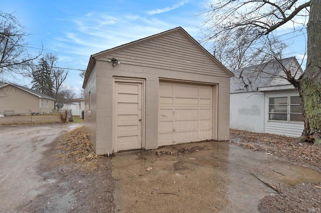 detached garage with concrete driveway