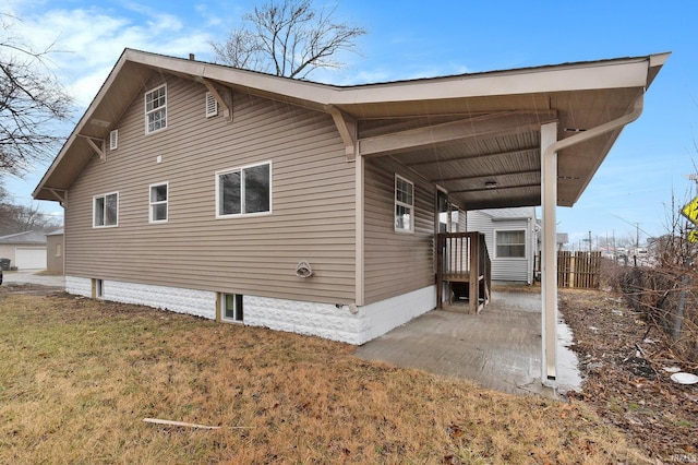 view of home's exterior with a yard and fence