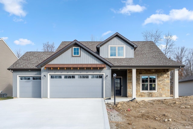 view of front of property featuring covered porch, concrete driveway, a shingled roof, and an attached garage