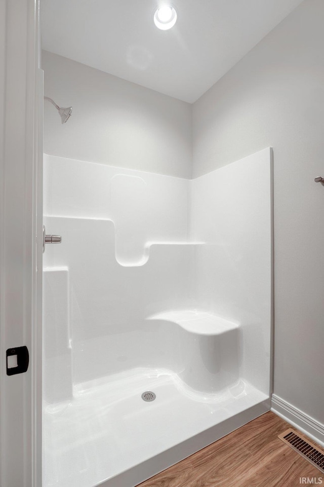 full bathroom with baseboards, visible vents, walk in shower, and wood finished floors