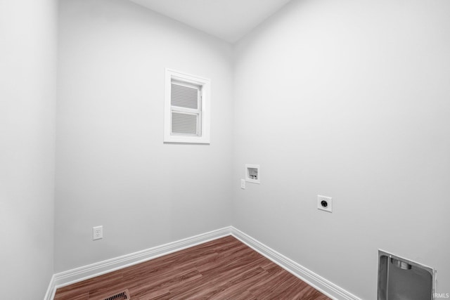 washroom featuring hookup for an electric dryer, laundry area, washer hookup, baseboards, and dark wood-style floors