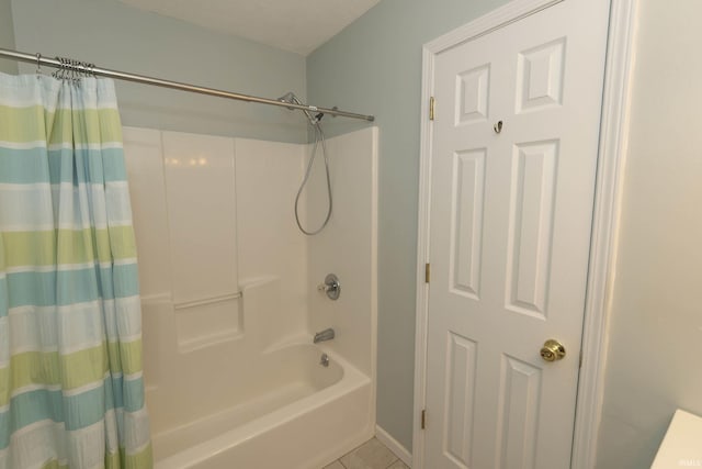 full bathroom featuring tile patterned flooring, shower / tub combo, and a textured ceiling