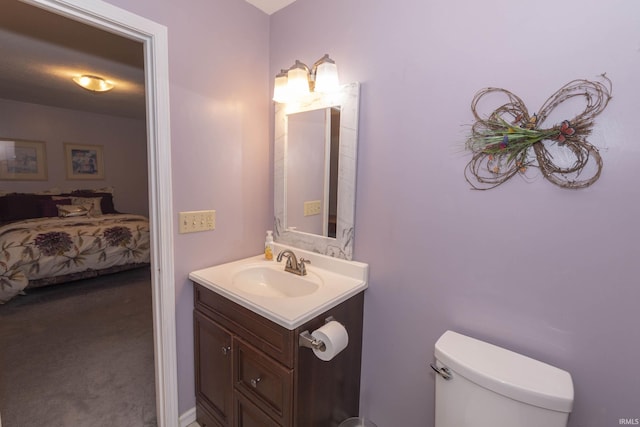 half bathroom featuring toilet and vanity