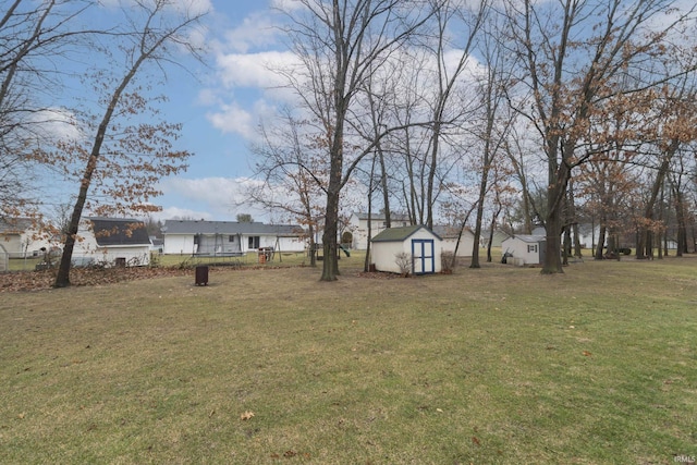 view of yard featuring an outdoor structure and a storage unit