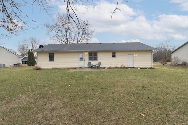 rear view of property with a lawn, a patio area, and cooling unit