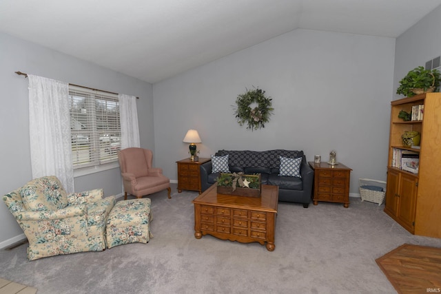 carpeted living area with vaulted ceiling, visible vents, and baseboards