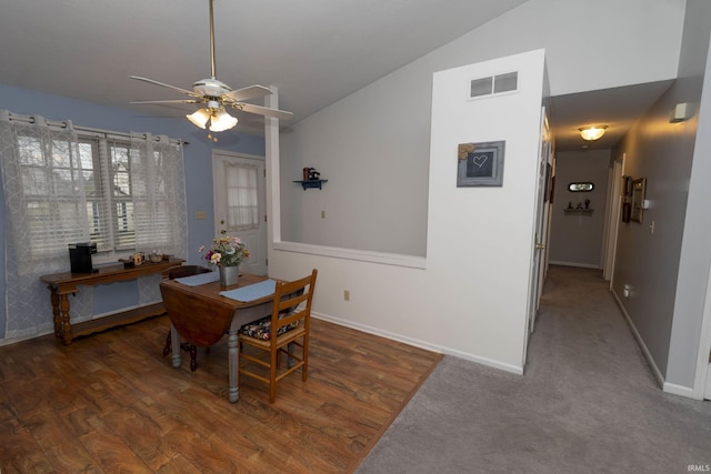 dining area with a ceiling fan, visible vents, vaulted ceiling, and baseboards