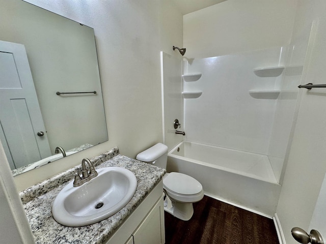 bathroom featuring vanity, shower / washtub combination, wood finished floors, and toilet