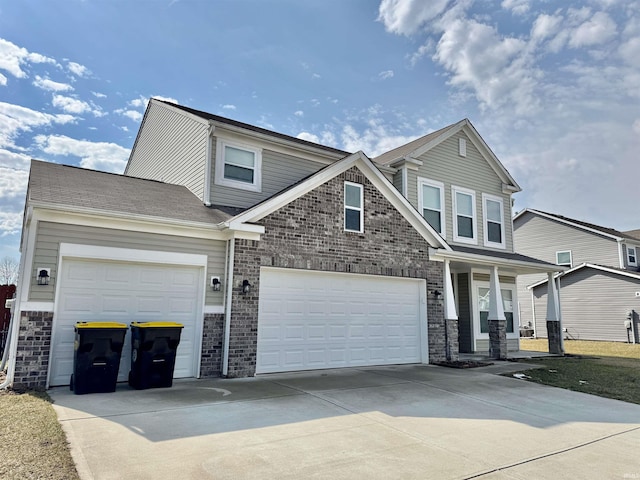 view of front of property with a garage, driveway, and brick siding