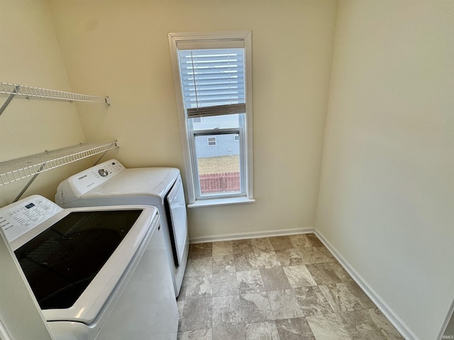 laundry room featuring laundry area, independent washer and dryer, and baseboards