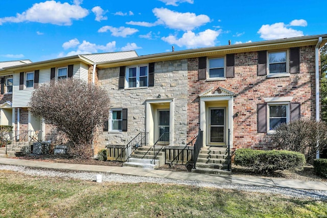 view of front of house with stone siding and central AC unit