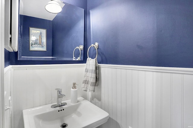 bathroom featuring wainscoting and a sink