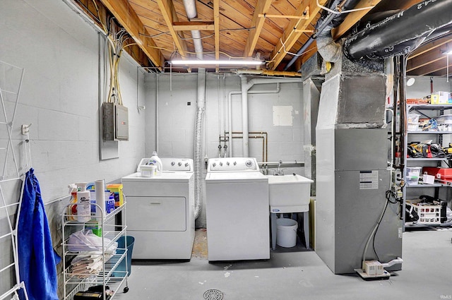 washroom with a sink, laundry area, and washer and dryer