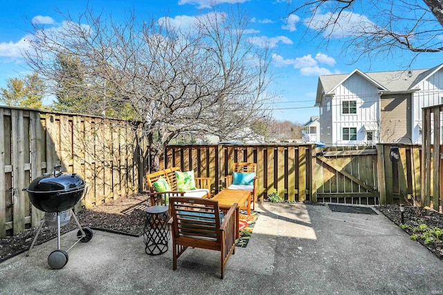 view of patio featuring a fenced backyard, a gate, and a grill