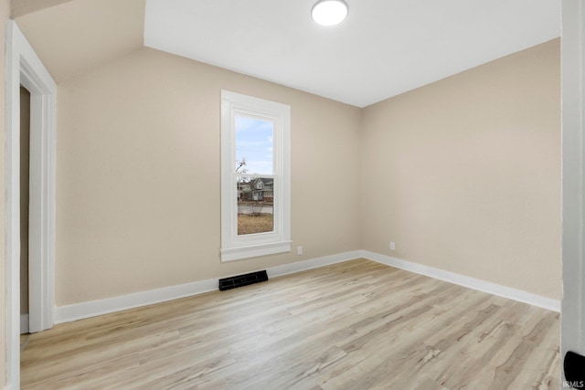 empty room featuring baseboards, visible vents, and light wood finished floors