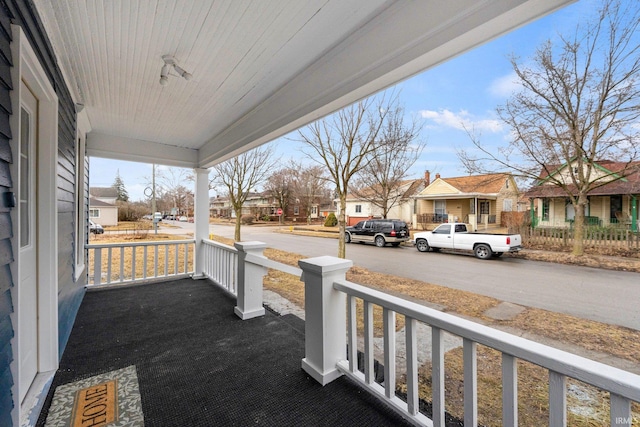 balcony featuring a residential view and covered porch