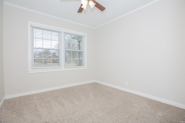 unfurnished room featuring carpet flooring, crown molding, baseboards, and ceiling fan