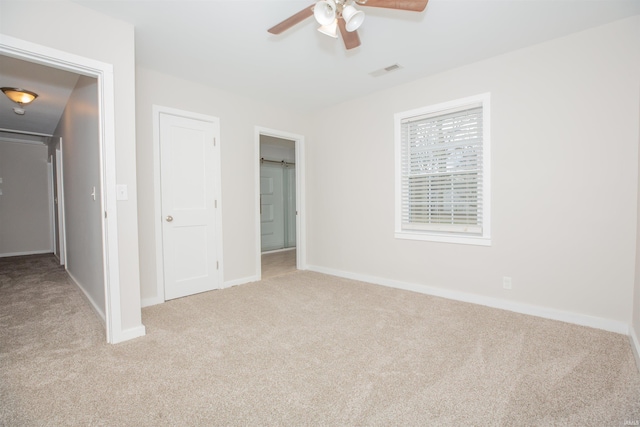 unfurnished bedroom featuring carpet floors, baseboards, and visible vents