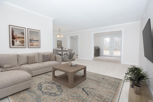 living area featuring baseboards, ornamental molding, and carpet flooring