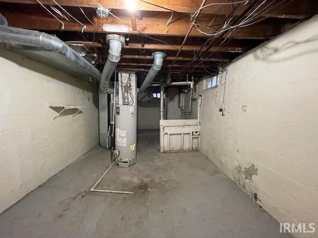 unfinished below grade area featuring gas water heater