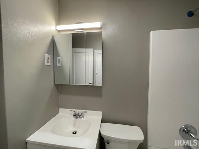 bathroom with toilet and vanity