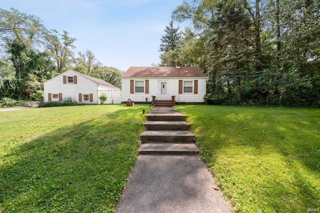 view of front of home featuring a front yard and a chimney