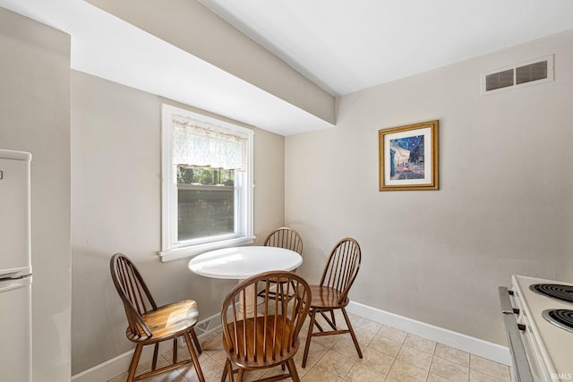 dining room with light tile patterned floors, visible vents, and baseboards