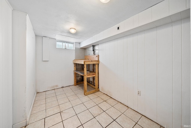 basement featuring light tile patterned floors