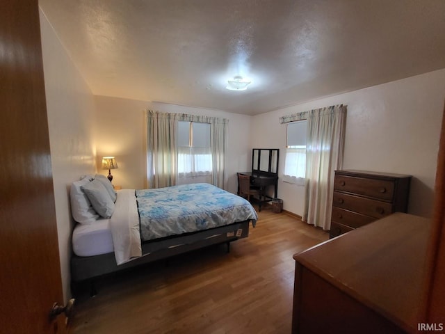 bedroom with wood finished floors