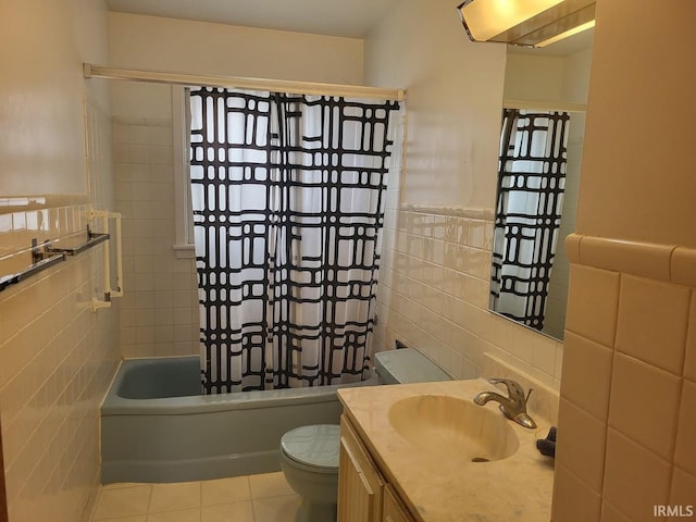 bathroom with shower / tub combo with curtain, tile walls, toilet, vanity, and tile patterned flooring