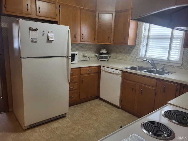 kitchen with white appliances, light countertops, a sink, and light floors