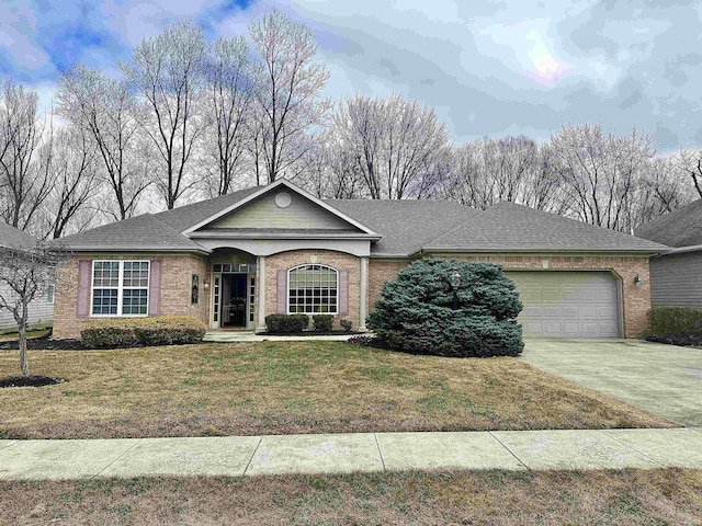 single story home with driveway, a front lawn, and brick siding