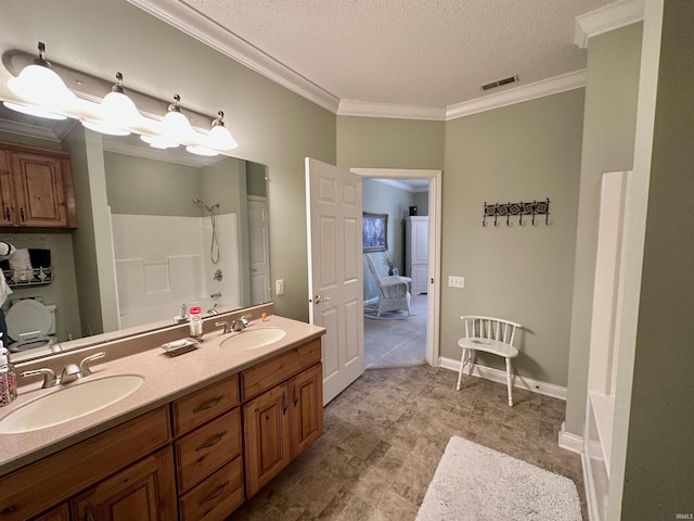 full bathroom with crown molding, a sink, and double vanity