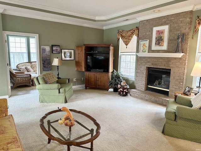 carpeted living area featuring ornamental molding, a fireplace, and baseboards