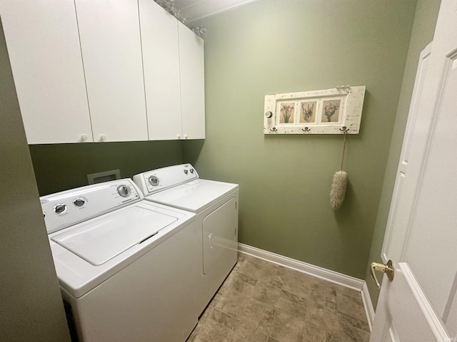 laundry room with washing machine and dryer, cabinet space, and baseboards