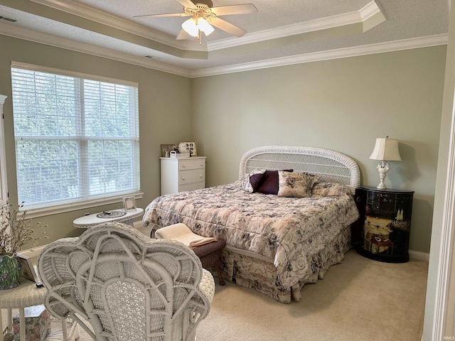 bedroom with carpet floors, crown molding, a raised ceiling, ceiling fan, and a textured ceiling