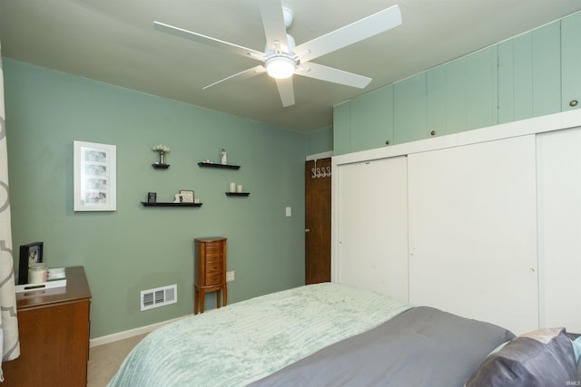 carpeted bedroom with a closet, visible vents, ceiling fan, and baseboards