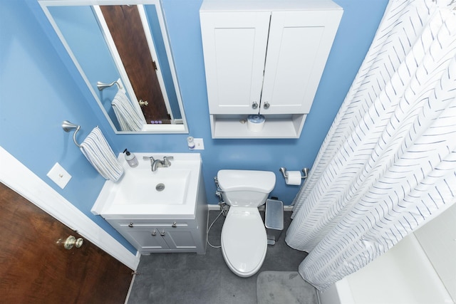 bathroom with toilet, baseboards, and vanity