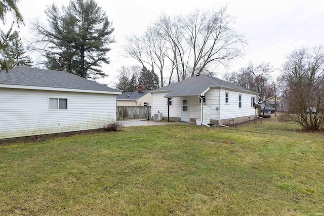 back of property with central AC, a lawn, fence, and a patio